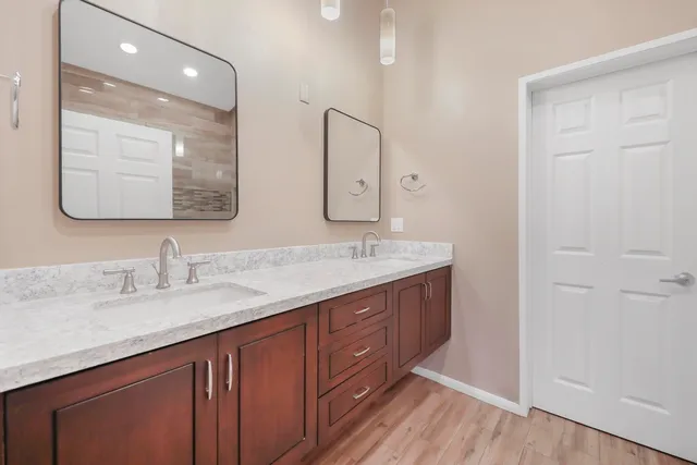 a bathroom with a double vanity sink and mirror
