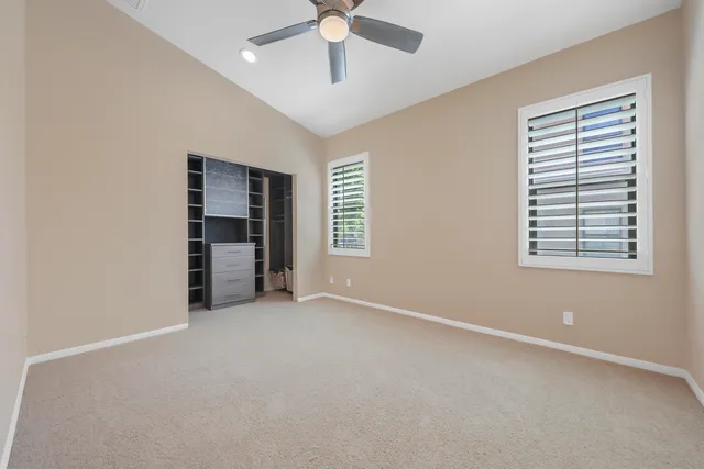 an empty room with windows and closet