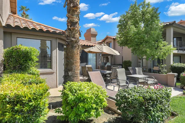 a view of a house with backyard sitting area and garden