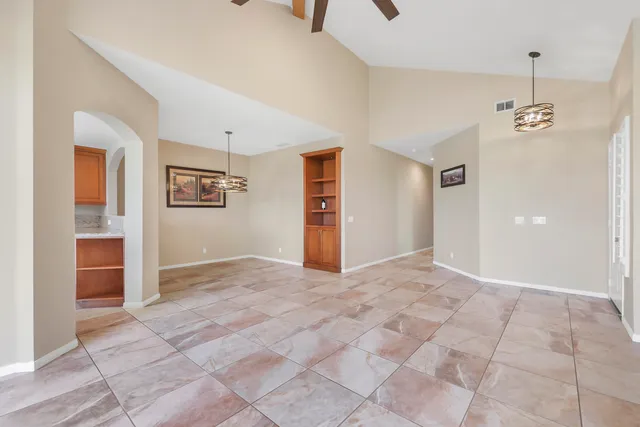 a view of empty room with cabinet and mirrors