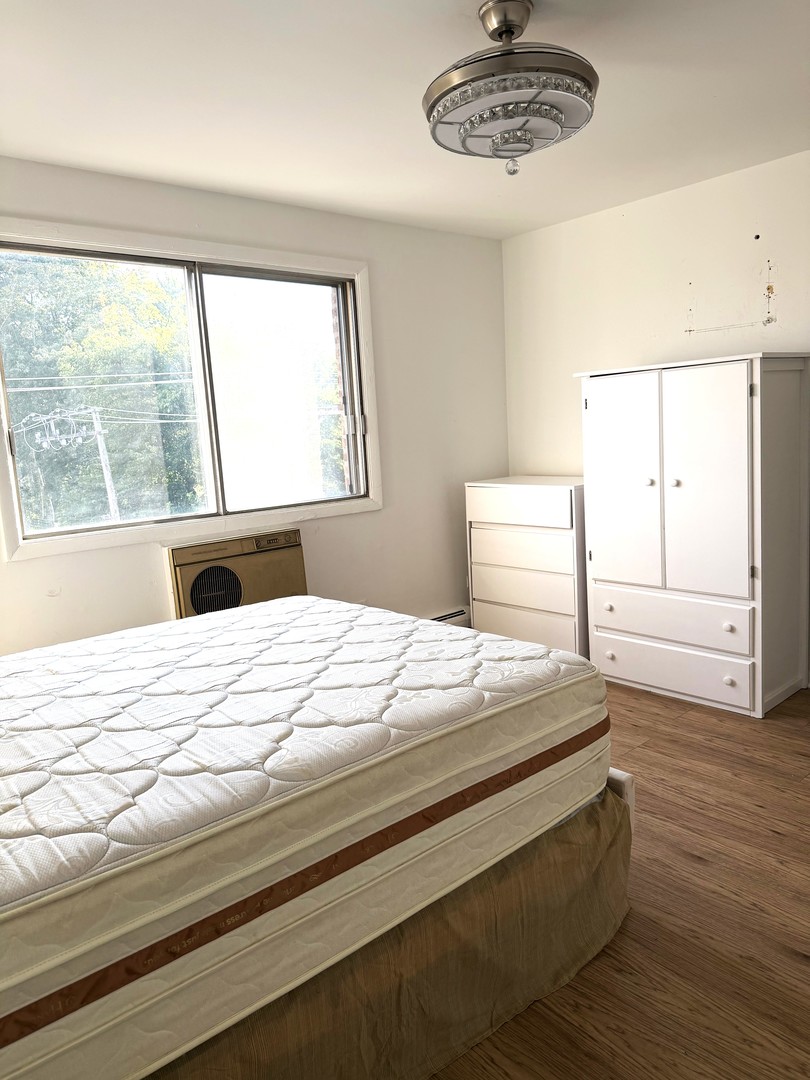 1415 West Pratt Boulevard, Unit 407 Chicago, IL 60626 - Photo 5 of 10 a bedroom with a bed and a window