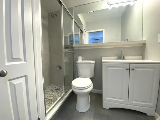 a kitchen with a sink cabinets and wooden floor