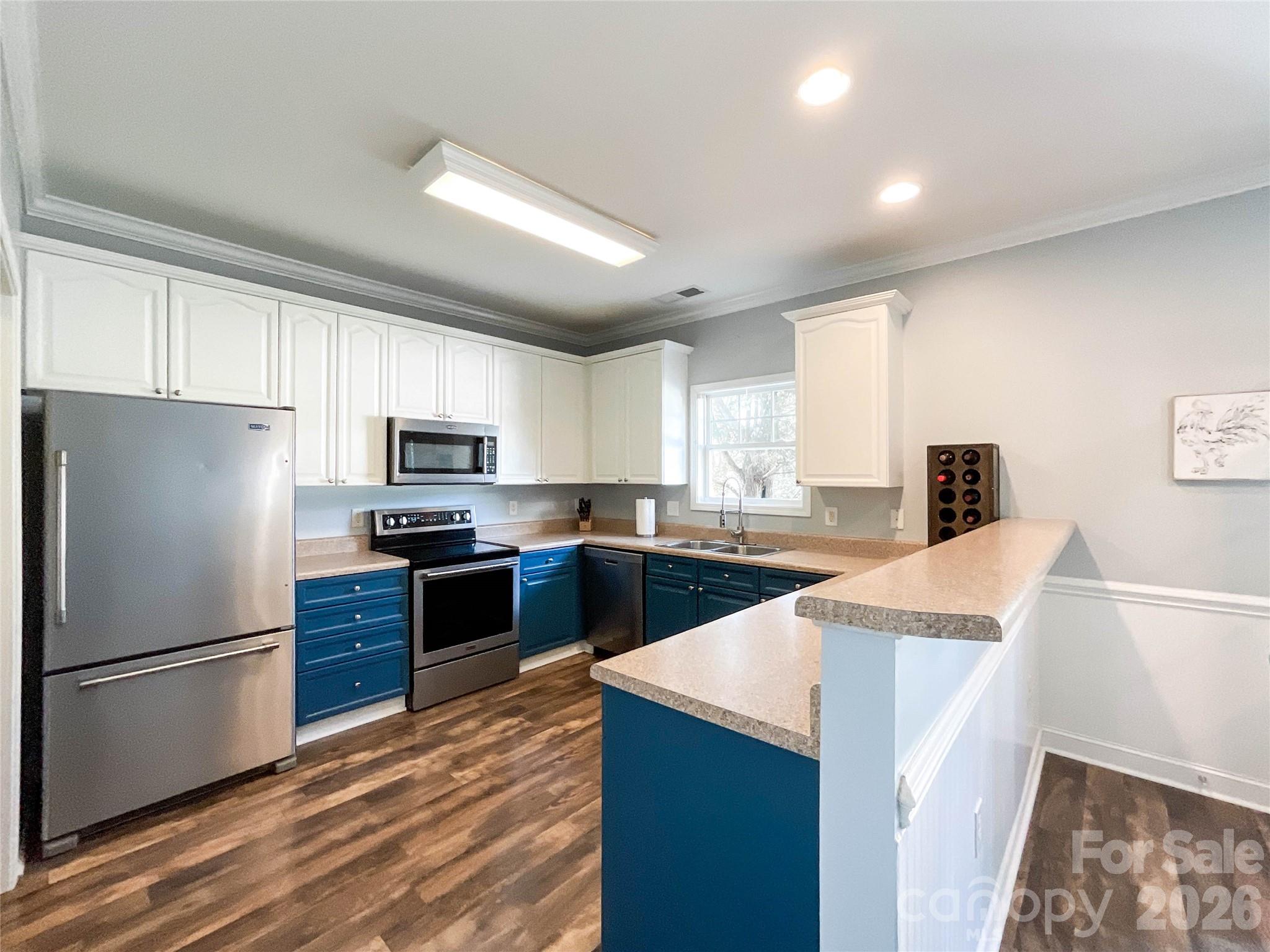 1007 Matilda Lane Indian Trail, NC 28079 - Photo 11 of 43 a kitchen with stainless steel appliances granite countertop a refrigerator stove microwave and sink