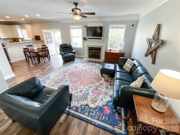 a living room with furniture fireplace and a window