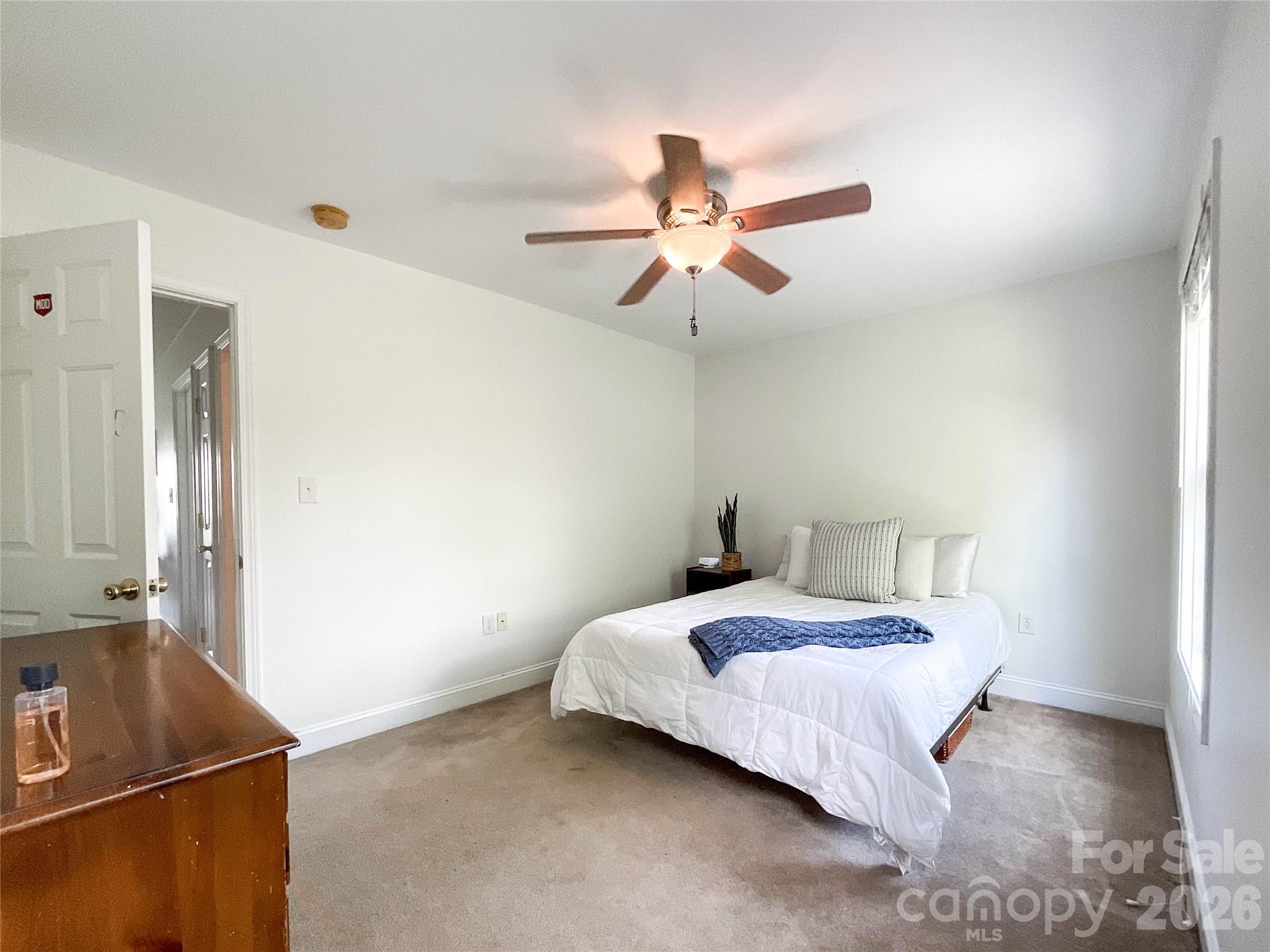 1007 Matilda Lane Indian Trail, NC 28079 - Photo 18 of 43 a bedroom with a bed and a chandelier