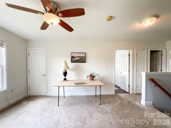 a living room with furniture and a ceiling fan