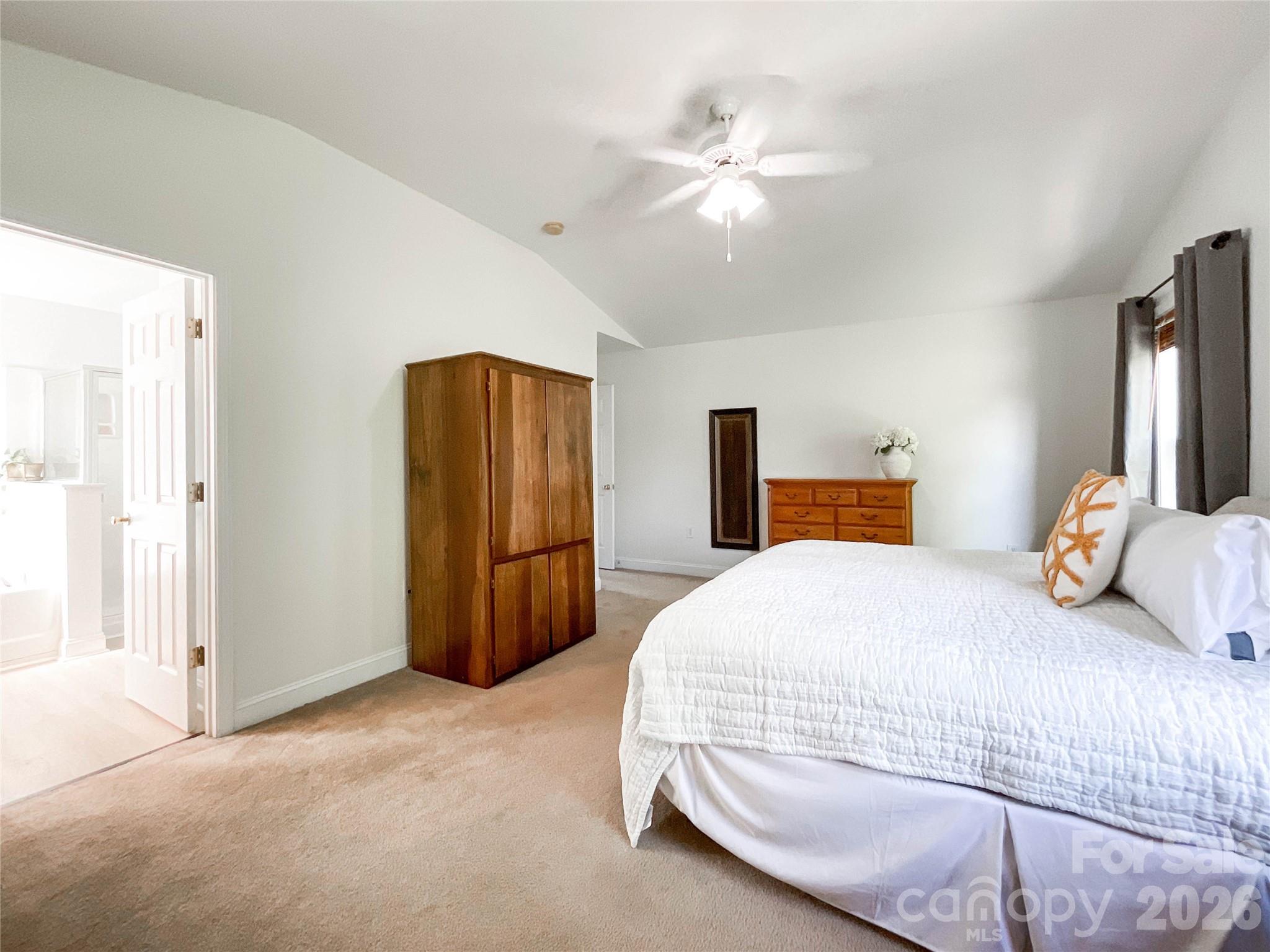 1007 Matilda Lane Indian Trail, NC 28079 - Photo 29 of 43 a bedroom with a bed and a chandelier