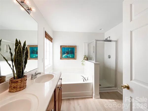 a bathroom with a tub sink and mirror