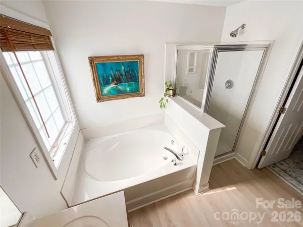 a bathroom with a bathtub and a window