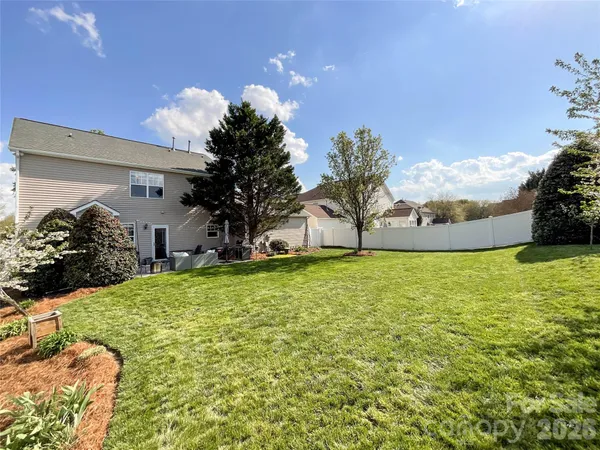 a view of a house with a yard and garage
