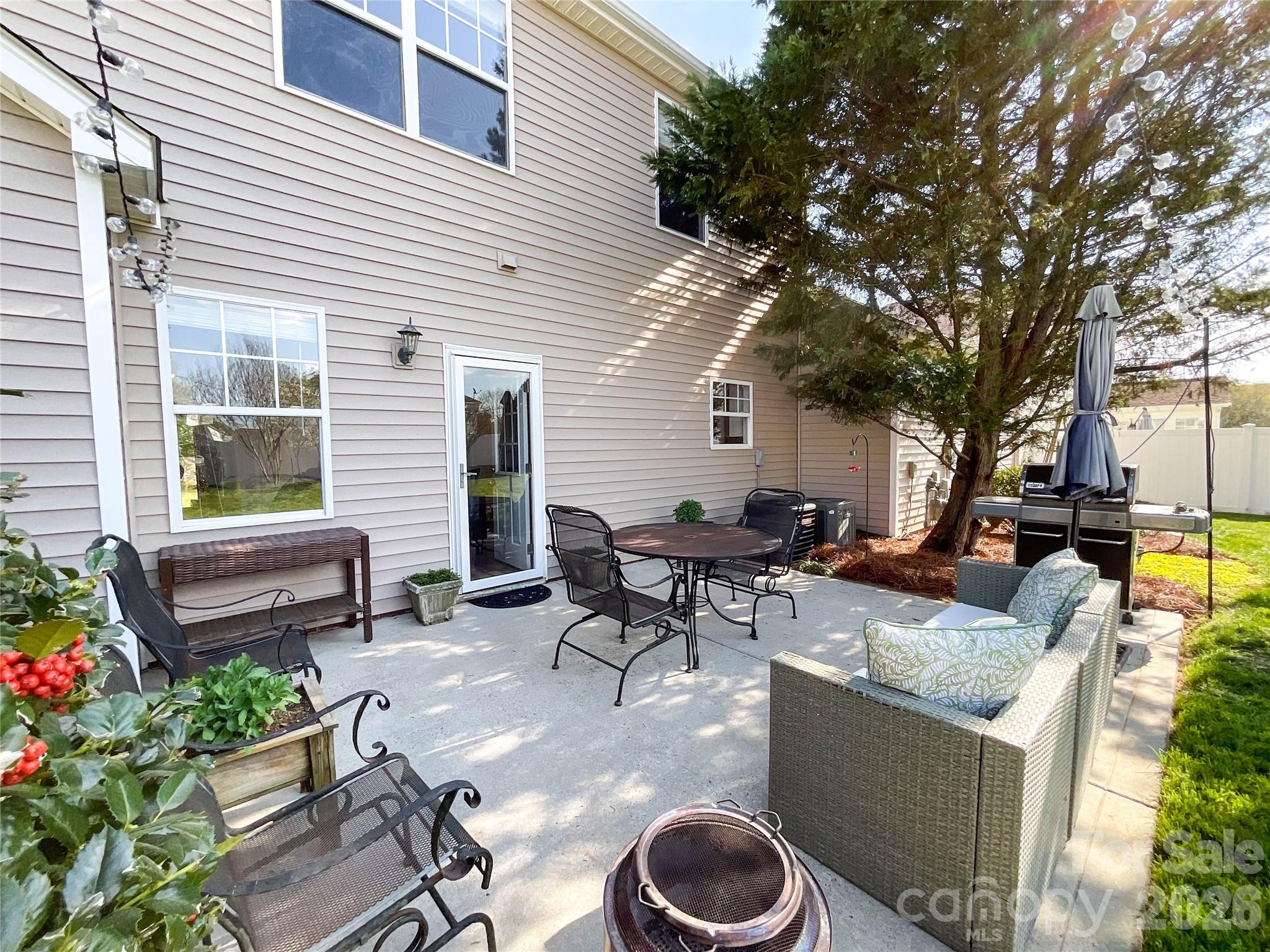 1007 Matilda Lane Indian Trail, NC 28079 - Photo 36 of 43 a view of a patio with couches table and chairs and potted plants