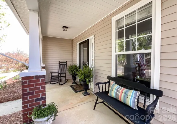 a building outdoor space with patio furniture and potted plants