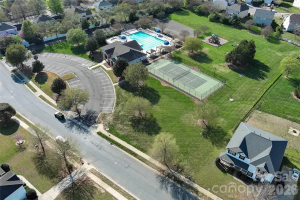 an aerial view of a house with garden space and street view