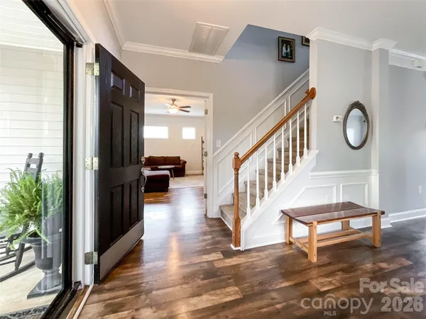 a view of staircase with lots of frames and flower garden