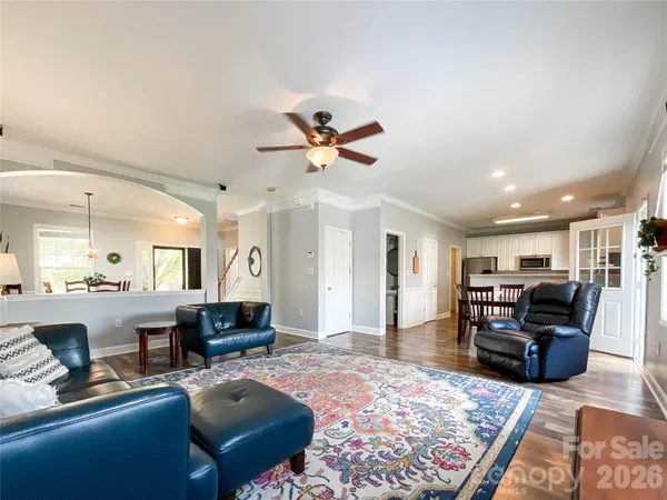a living room with furniture a fireplace and a chandelier