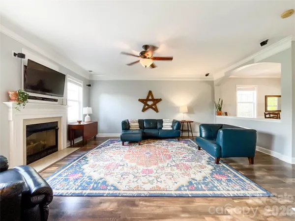 a living room with furniture and a fireplace