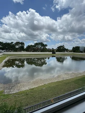 a view of a lake with houses in the back