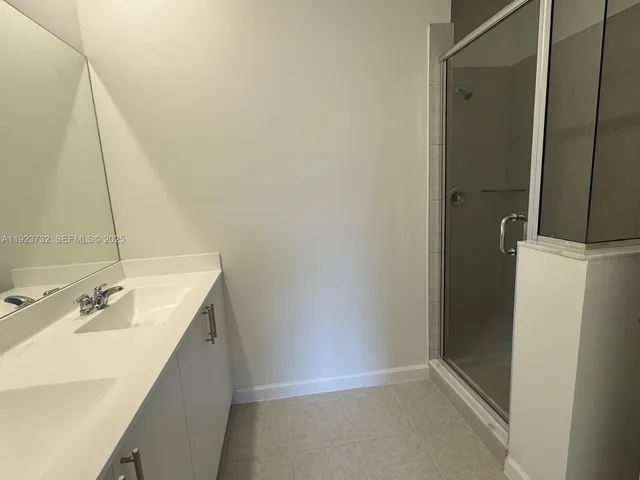 a bathroom with a sink and shower