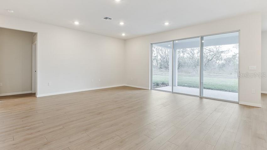 1925 Cobb Trail Parrish, FL 34219 - Photo 8 of 25 a view of an empty room with wooden floor and a window