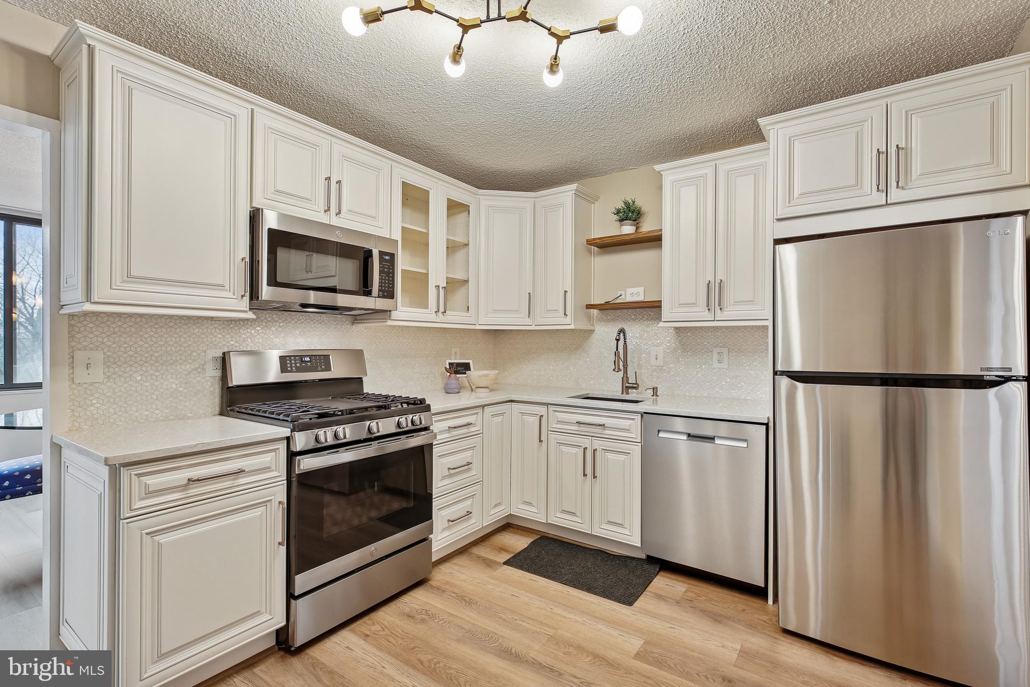 5225 Pooks Hill Road, Unit 629S Bethesda, MD 20814 - Photo 11 of 58 a kitchen with cabinets stainless steel appliances and wooden floor