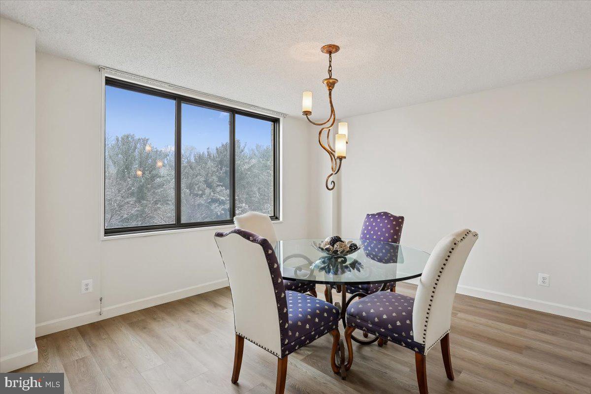 5225 Pooks Hill Road, Unit 629S Bethesda, MD 20814 - Photo 12 of 58 a view of a dining room with furniture window and wooden floor