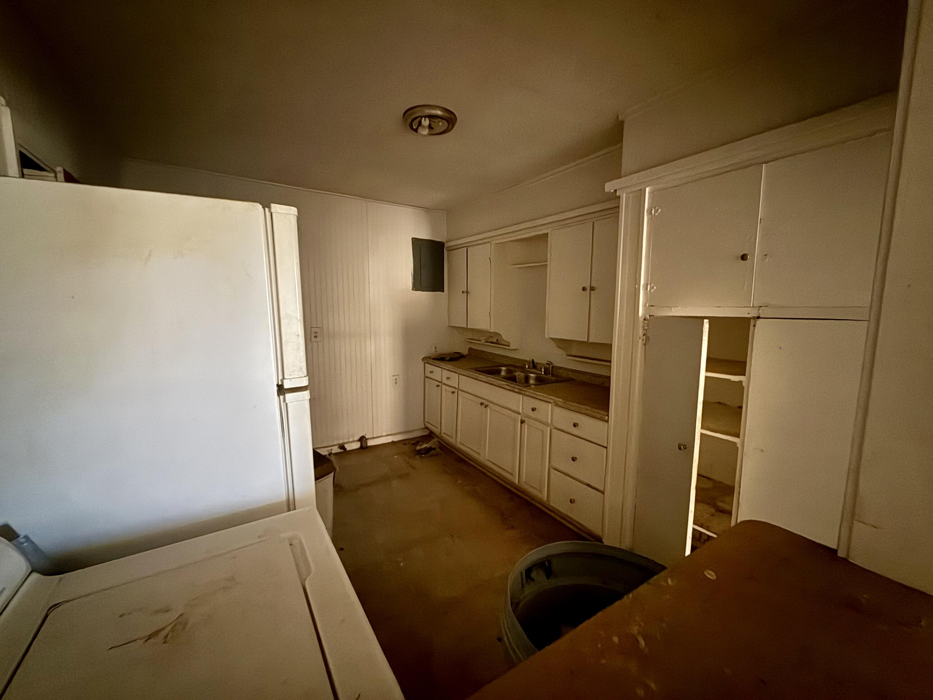 6119 20th Street Lubbock, TX 79407 - Photo 8 of 9 a kitchen with white cabinets and white appliances
