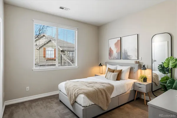 a bedroom with bed and a window