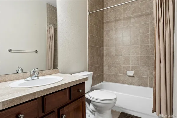 a bathroom with a sink a toilet and bathtub