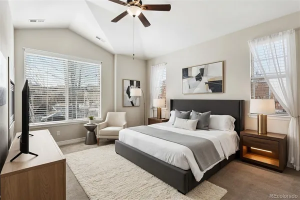 a bedroom with a large bed and a couch