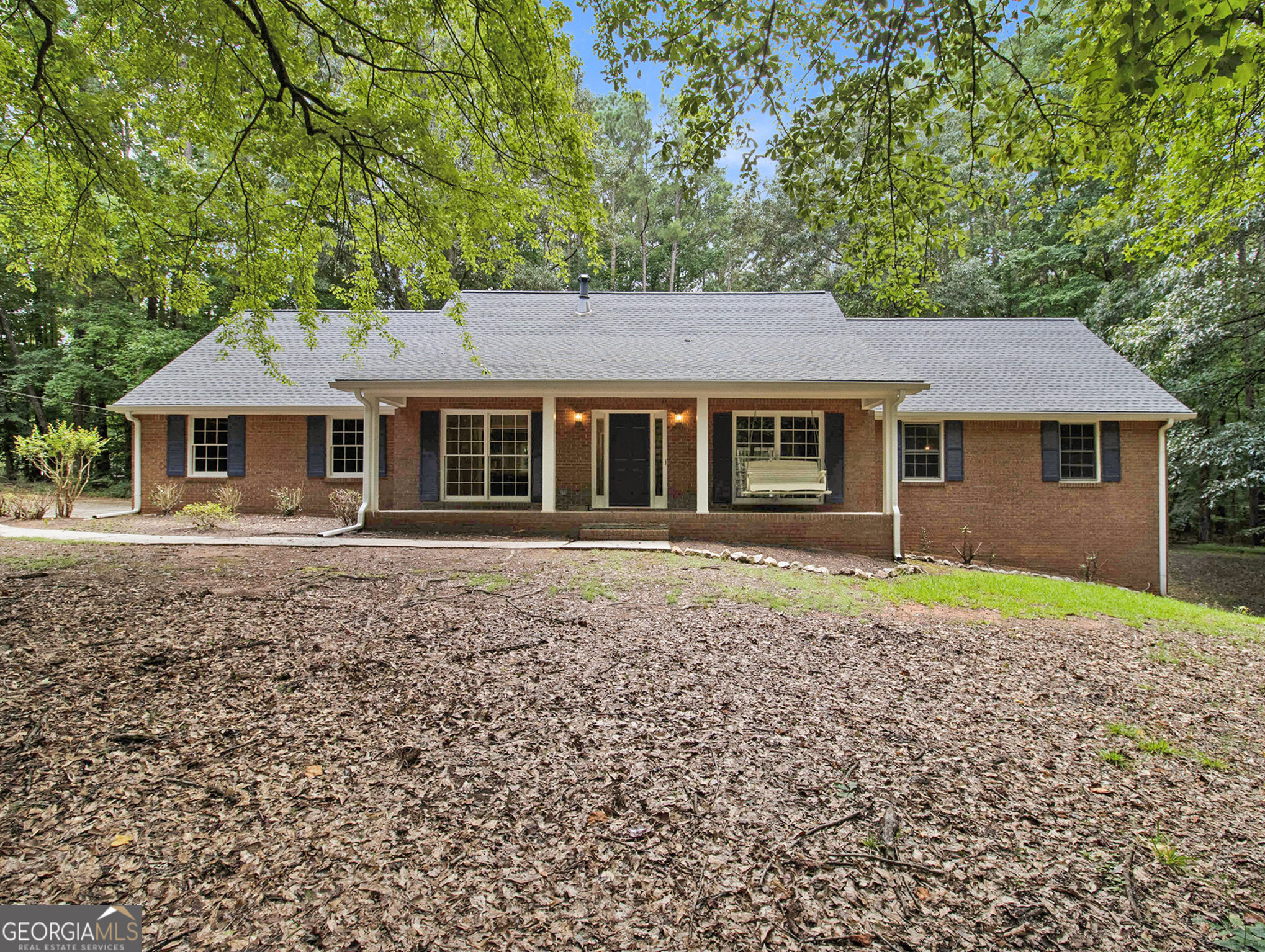 313 Nelms Road Fayetteville, GA 30215 - Photo 1 of 1 a house with green field in front of it
