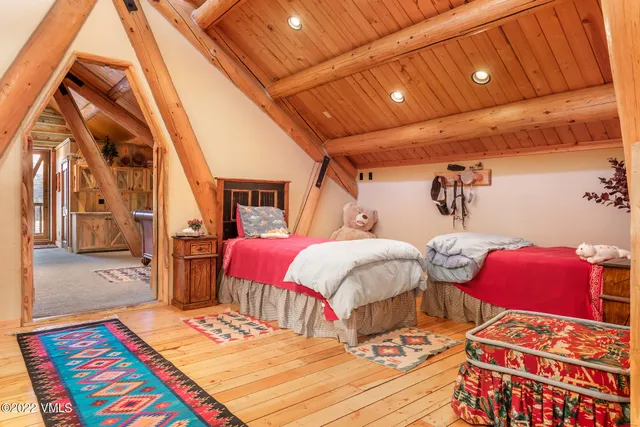 a bedroom with furniture and a large window