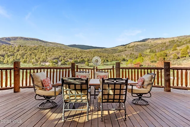 a view of a house with garden and lawn chairs