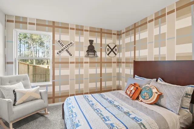 a bedroom with a bed and a couch next to a window