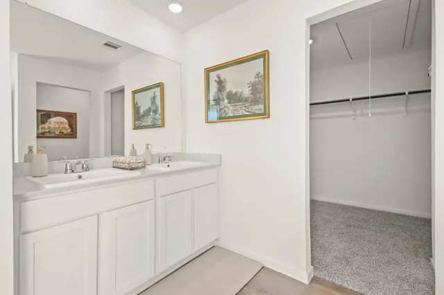 a bathroom with a double vanity sink and a mirror