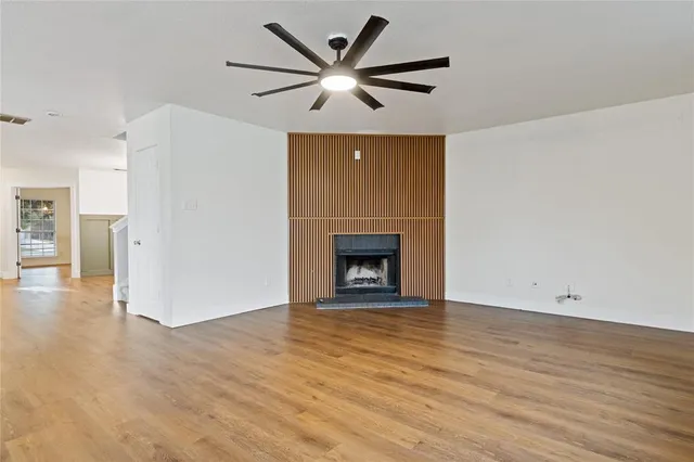 wooden floor in an empty room with a fireplace