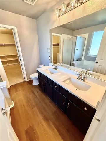 a spacious bathroom with a double vanity sink and a mirror