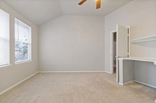 an empty room with windows and closet