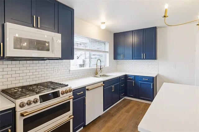 a kitchen with wooden cabinets and stainless steel appliances