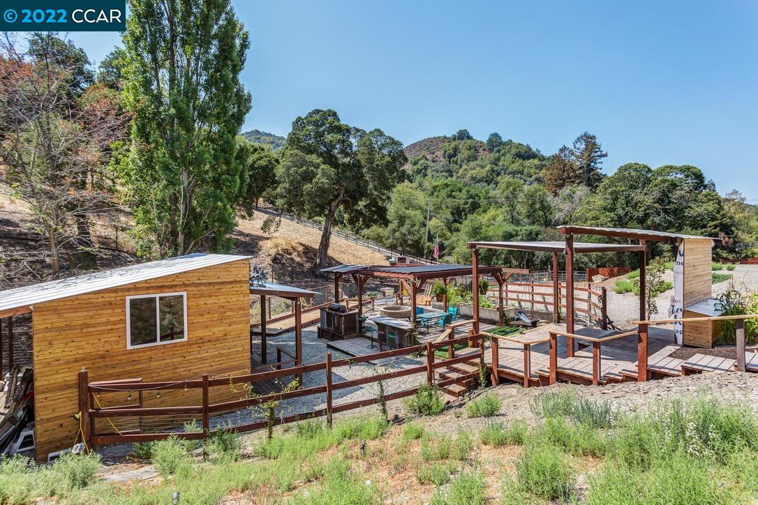 a view of a patio with table and chairs under an umbrella