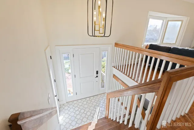 a view of a hallway with wooden floor and stairs