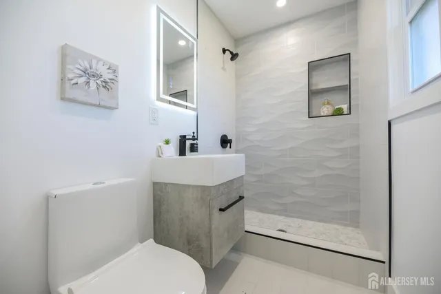 a bathroom with a sink toilet and vanity