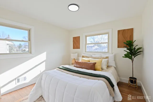a bedroom with a large bed and a potted plant