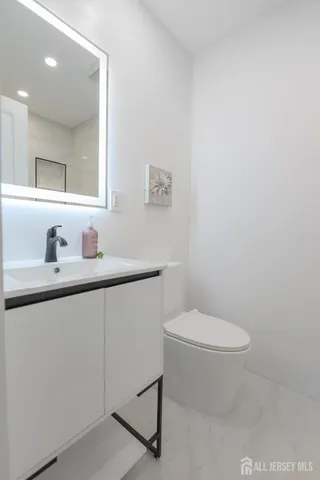 a bathroom with a sink toilet and mirror