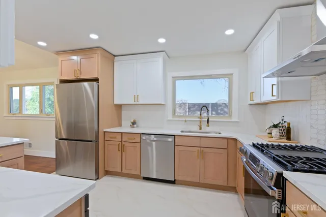 a kitchen with stainless steel appliances granite countertop a sink stove and refrigerator