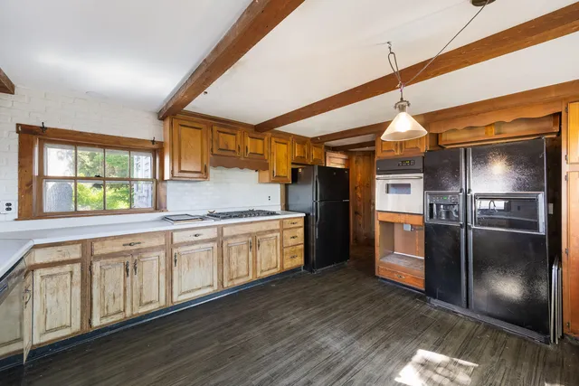 a kitchen with granite countertop stainless steel appliances a refrigerator microwave and sink