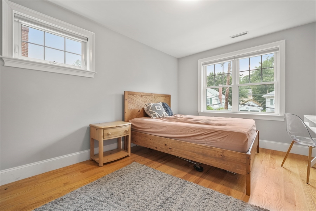 26 Brookfield Road Waltham, MA 02452 - Photo 12 of 37 a bedroom with a bed and wooden floor