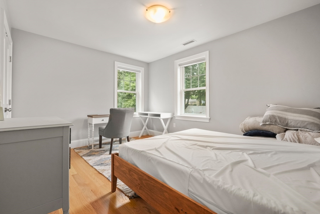 26 Brookfield Road Waltham, MA 02452 - Photo 13 of 37 a bedroom with a bed and large windows