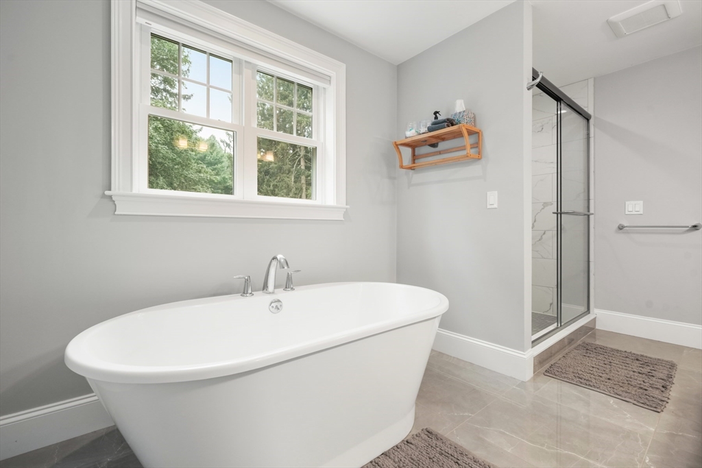 26 Brookfield Road Waltham, MA 02452 - Photo 22 of 37 a white bath tub sitting next to a window