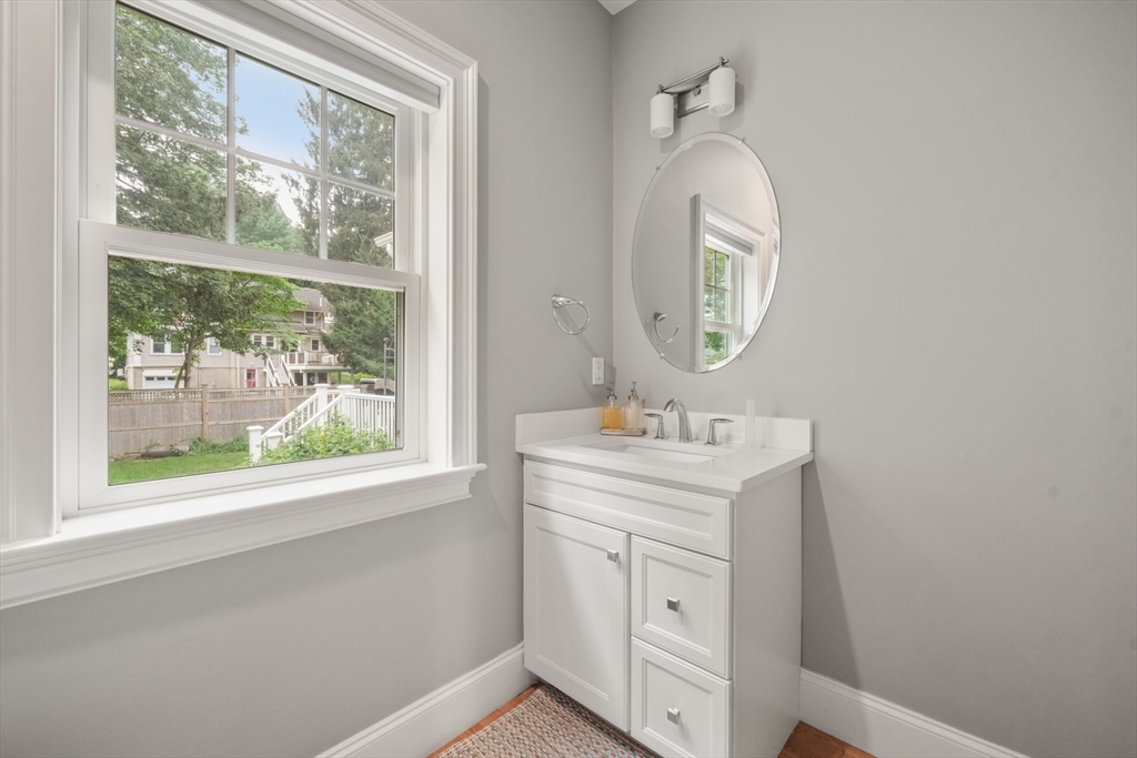 26 Brookfield Road Waltham, MA 02452 - Photo 23 of 37 a bathroom with a toilet a sink and a mirror