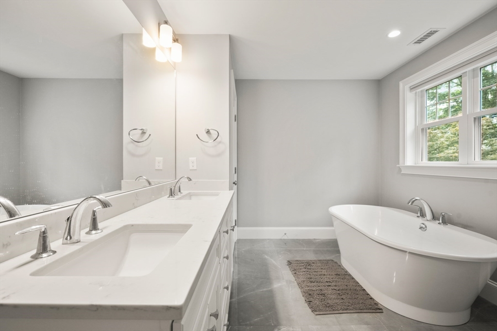 26 Brookfield Road Waltham, MA 02452 - Photo 27 of 37 a bathroom with a tub sink and mirror